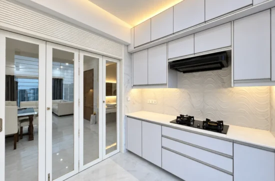 Pale kitchen cabinets, textured backsplash, warm lighting, and glazed doors in an edited AG Bashundhara portfolio image.